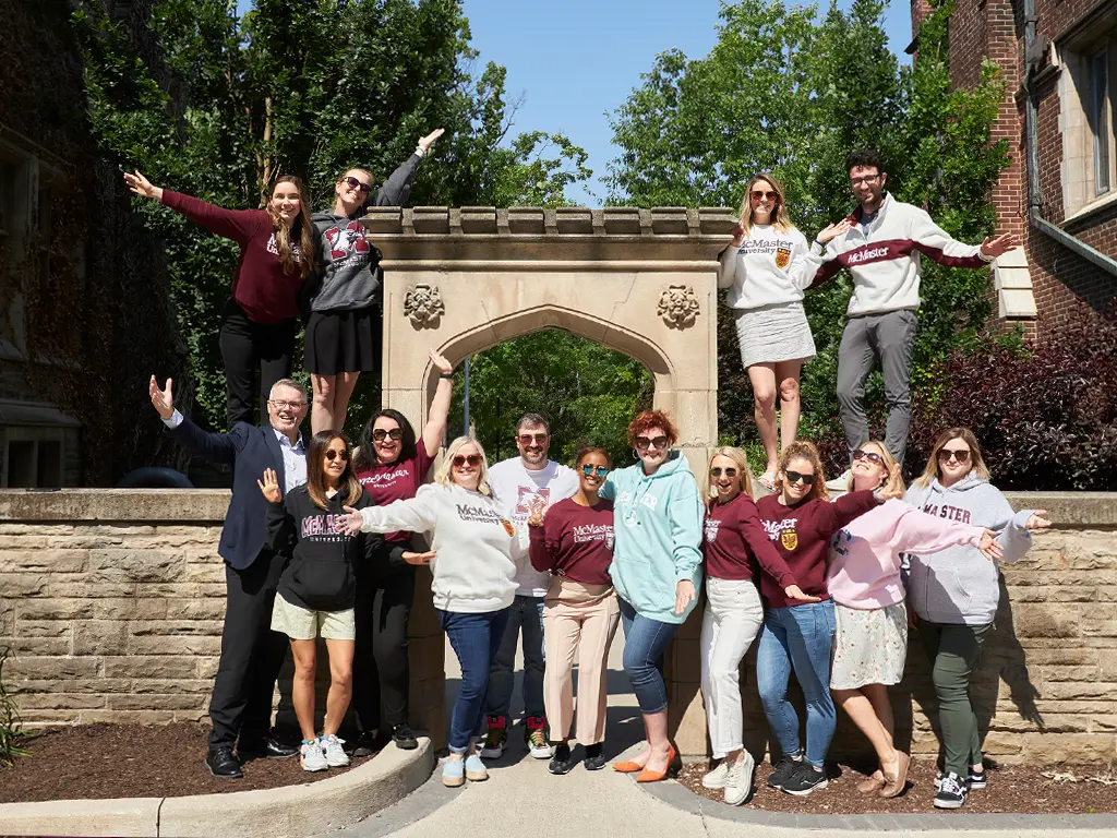 Students in the Capstone Research Course (COM MGMT 740) pose by Edwards Arch with Dr. Terry Flynn